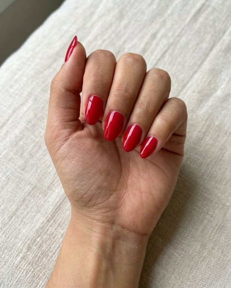 Vivid cool red polish on a sample hand: Bright Winter